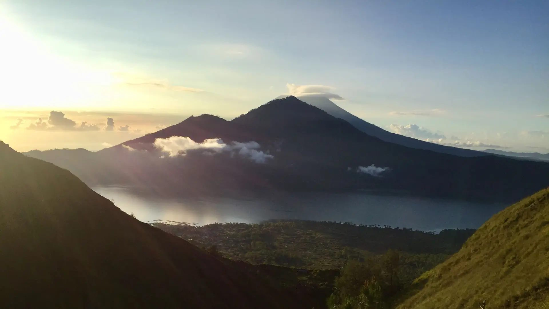 Mount Batur at sunrise, with Lake Batur and the caldera below